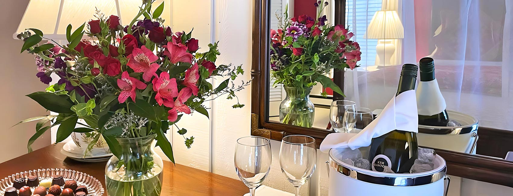 bubbly, flowers and chocolates waiting in room